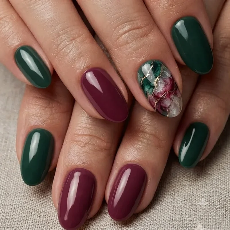 Dark boho nails in deep berry and forest tones with a marbled crystal-effect accent nail