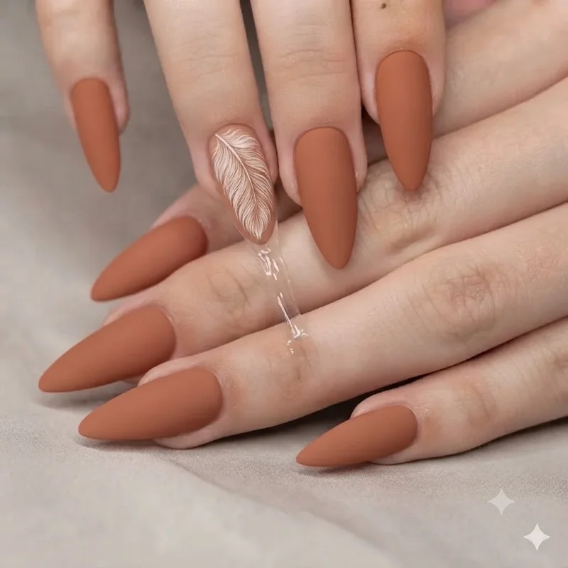 Signature boho nails in terracotta with a hand-drawn feather accent nail and matte finish