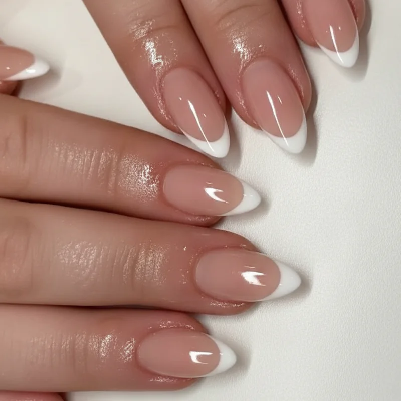 Micro French tip quiet luxury nails showing hairline white tip on almond shape with milky base for the most elevated understated design in 2026