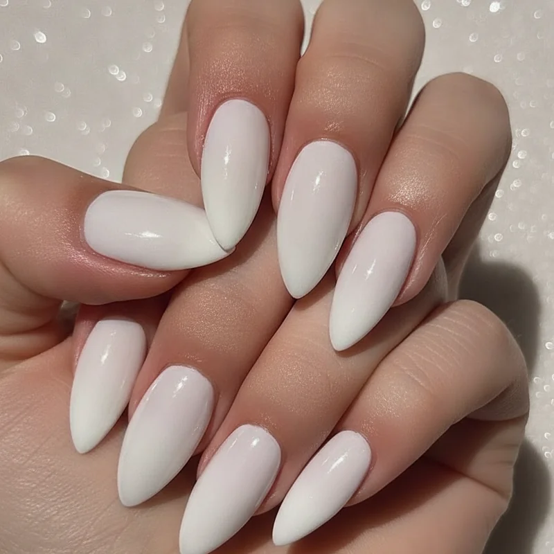Close-up of quiet luxury nails showing the three elements that make nails look expensive: almond shape, milky gloss finish, and immaculate cuticle preparation