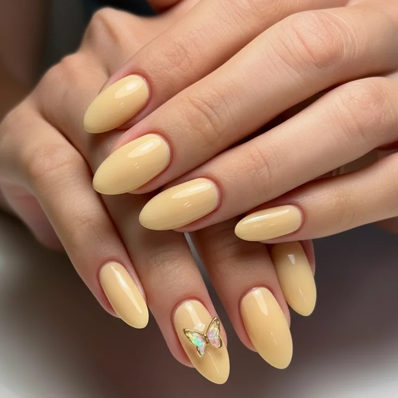 Butter yellow glaze short almond nails with soft high shine finish flattering across multiple skin tones 2026