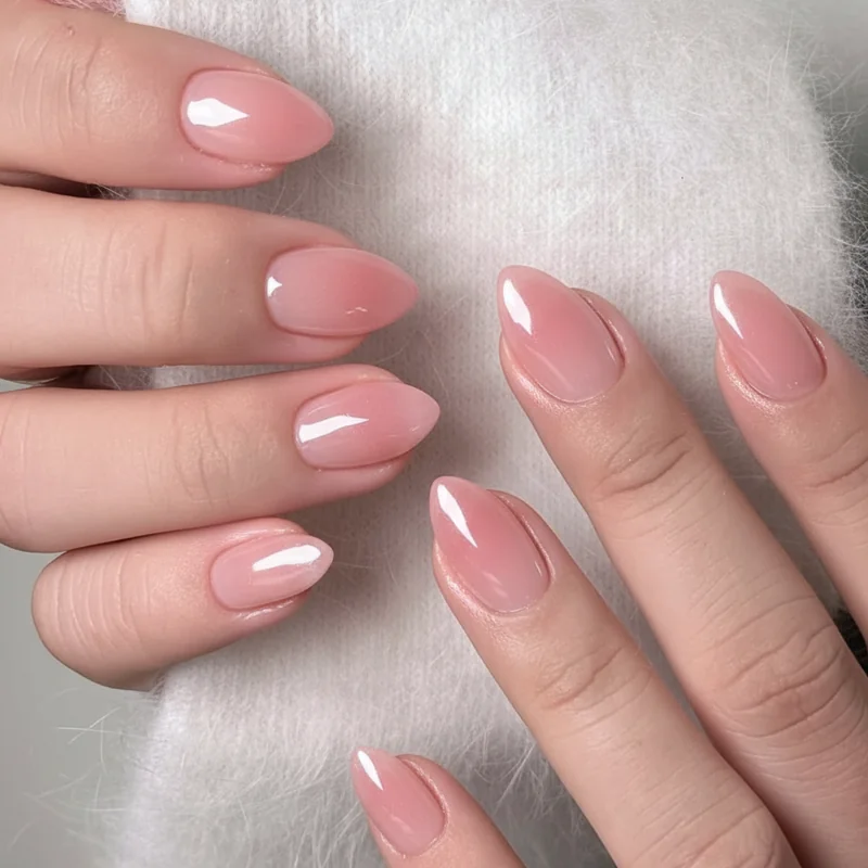 Classic sheer pink glossy almond nail inspo with light catching finish for elegant wearable everyday manicure