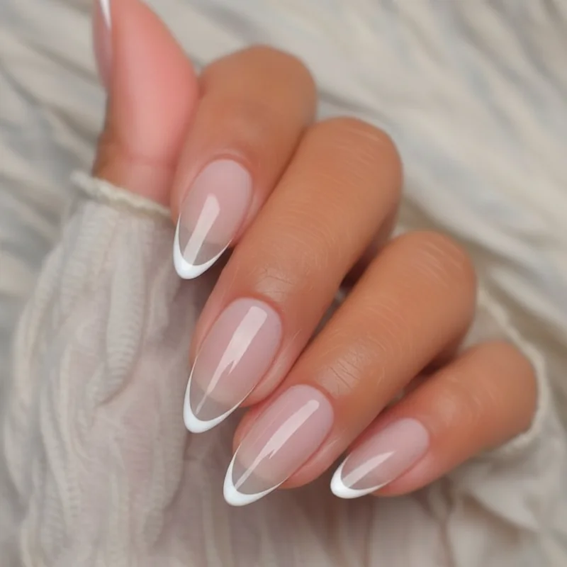 Micro French tip almond gel nails with glasswing sheer base showing ultra-thin smile line manicure 2026