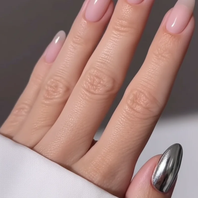 Single chrome accent nail on sheer almond base for minimalist elegant nail design that looks expensive simply