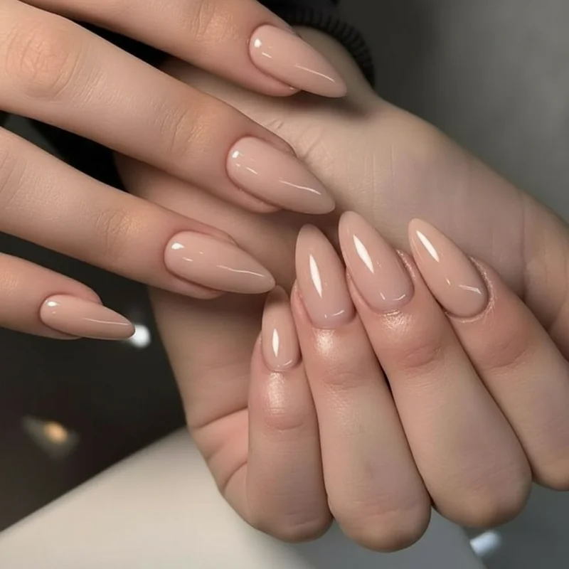 Almond nail shape anatomy diagram showing slim tapered sides curving to a soft rounded peak with free edge and nail bed labelled