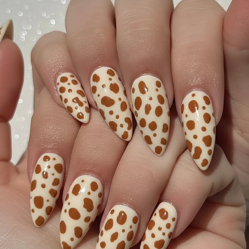 Bambi nails DIY technique with bobby pin dotting tool applying cream fawn speckle clusters on warm brown caramel base at home tutorial