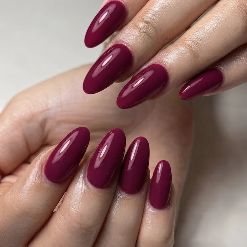 Deep berry wine manicure on pale skin, a rich contrast shade for pink undertone skin tones