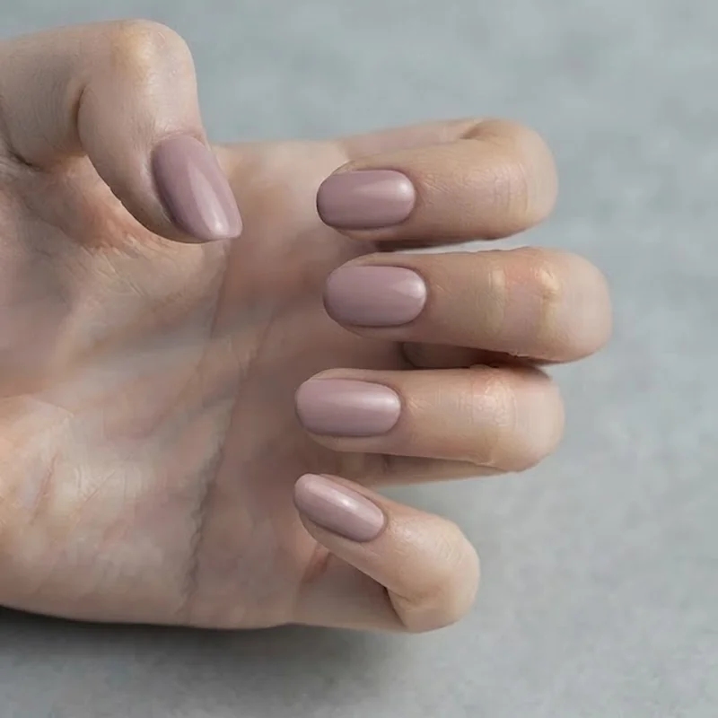 Soft mauve dusty rose manicure on pale skin, an everyday nail shade for pink undertone skin