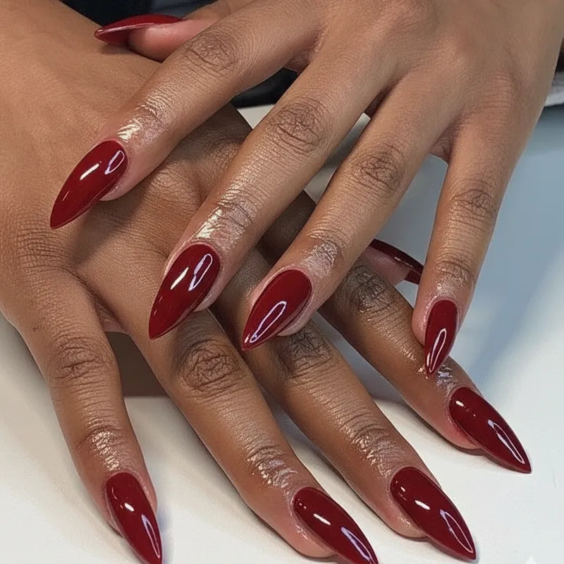 Cherry red and oxblood nail polish on deep dark skin with high-contrast cool and warm red nail options for every melanin skin