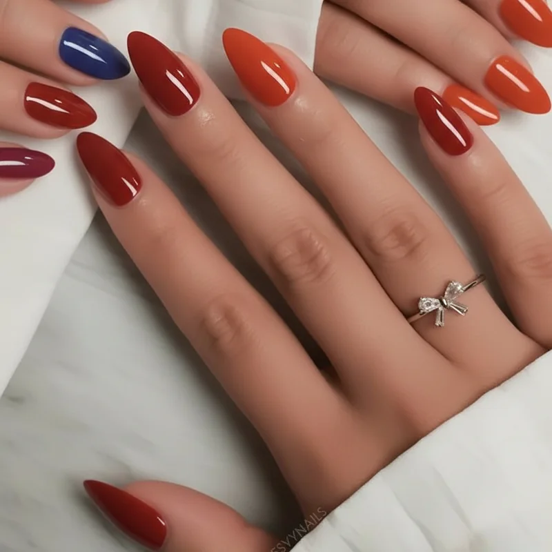 Cool cherry red versus warm tomato red nail polish swatches showing blue versus orange pigment base difference for skin tone