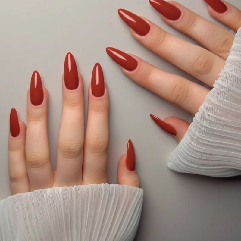 Tomato brick warm orange red nail polish on medium tan skin showing golden warmth amplification and a bronzed natural result