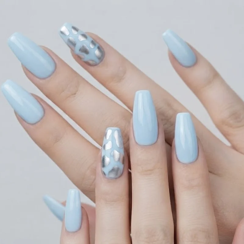 Baby blue and silver cow print nail design with modern Cowboy Carter twist on classic western pattern