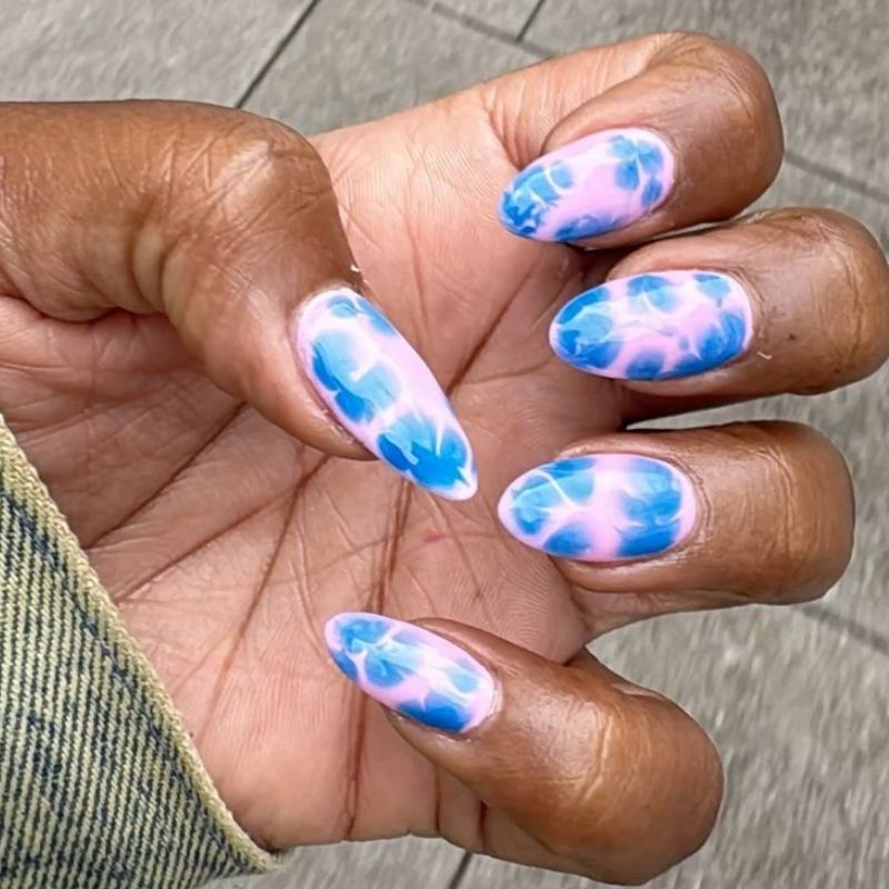 Blooming gel watercolor effect in progress showing pink and blue gel dispersing naturally