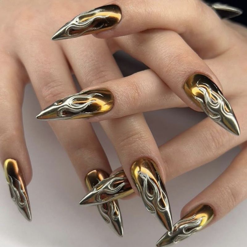 Bold metallic nail art with geometric patterns and mixed chrome finishes for NYE