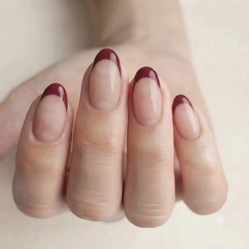 Colored French tip on short braider fingers in deep burgundy shade