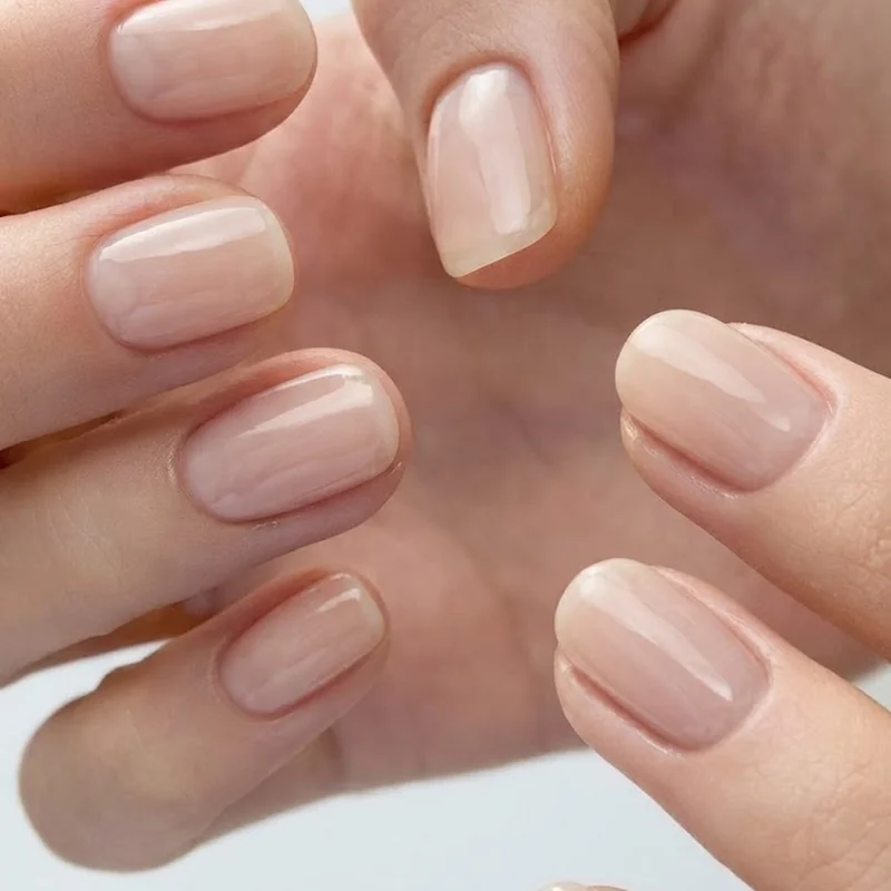 Finished at-home British manicure with glossy sheer top coat and neatly groomed cuticles