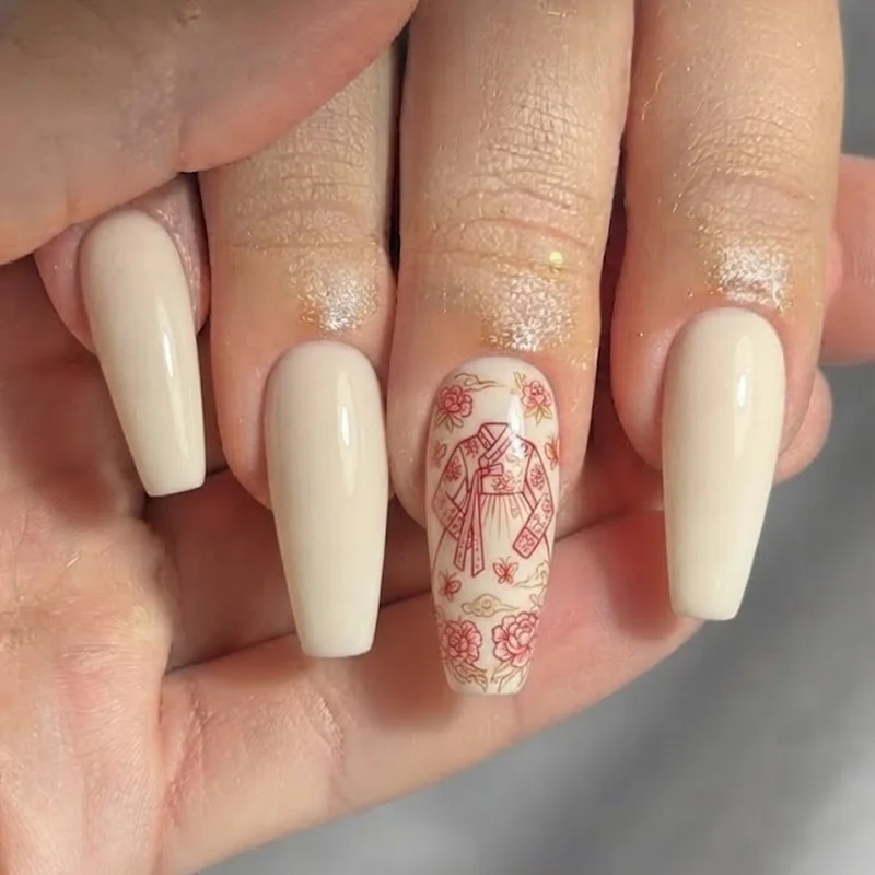 Hand-painted hanbok silhouette accent nail in red and gold linework on a cream base, folk motif detail