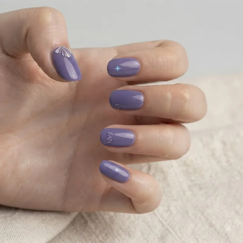 Short length BTS themed nail set proving the trend works without long nail extensions