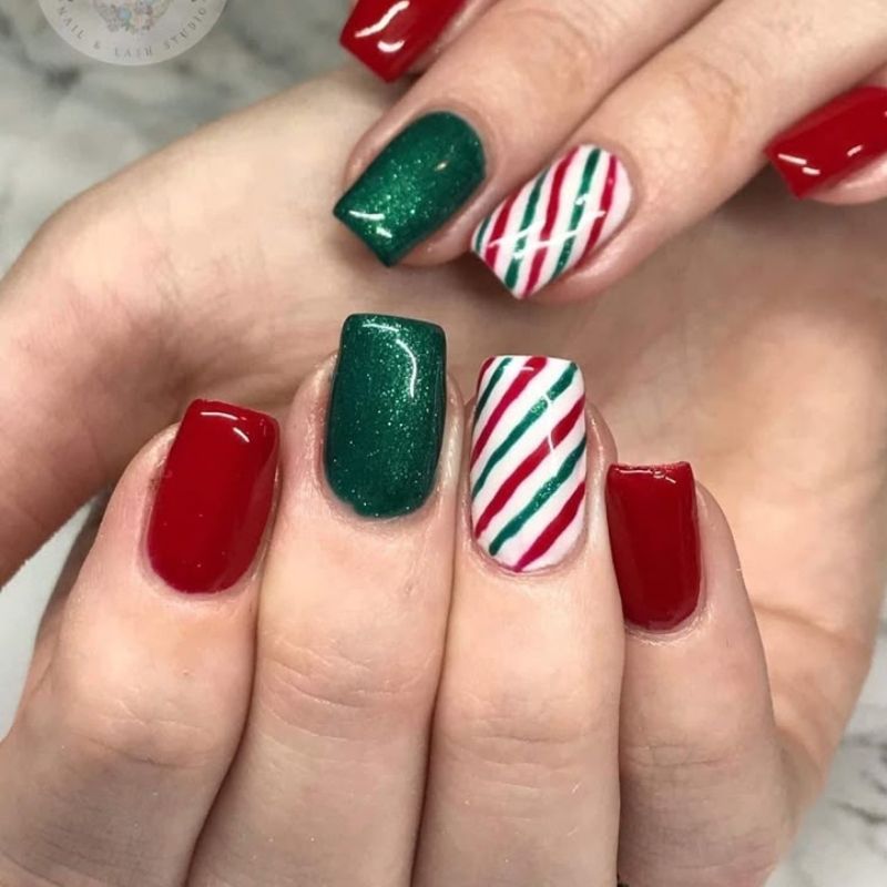 Candy cane stripe christmas nails on green base