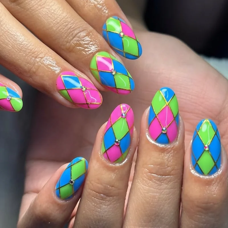 Harlequin nail art with multicoloured gems in checked pattern on three nails and abstract psychedelic shimmer design on pinkies camp festival set