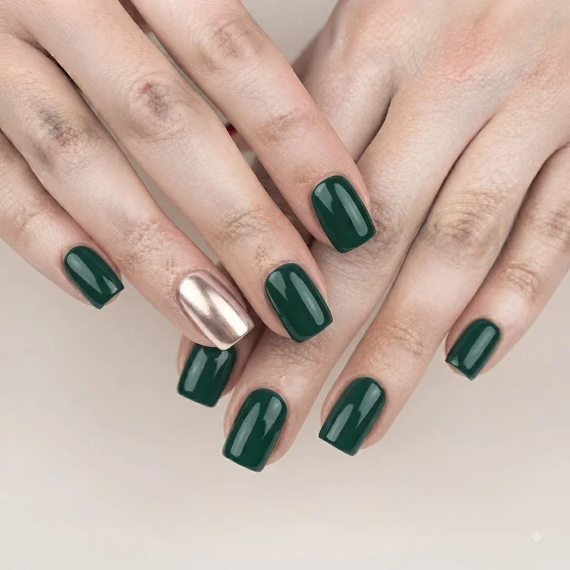Emerald green coffin christmas nails with a glossy chrome accent finish for a festive holiday manicure and party season look