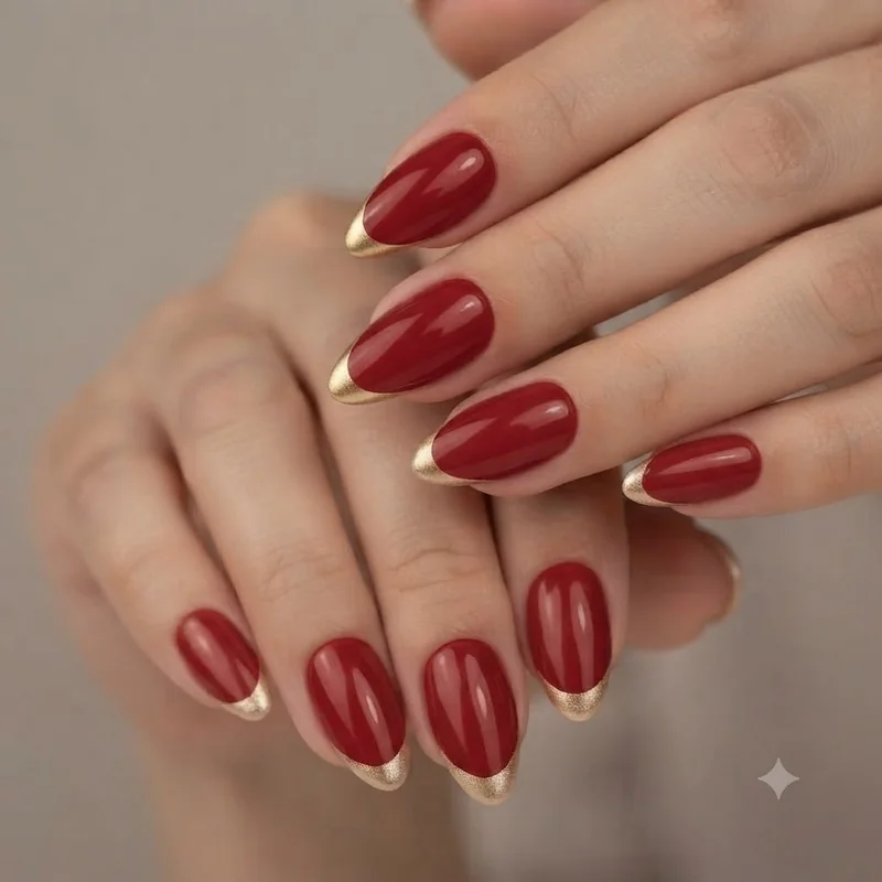 Red and gold christmas nails with gold french tips on a classic almond holiday manicure