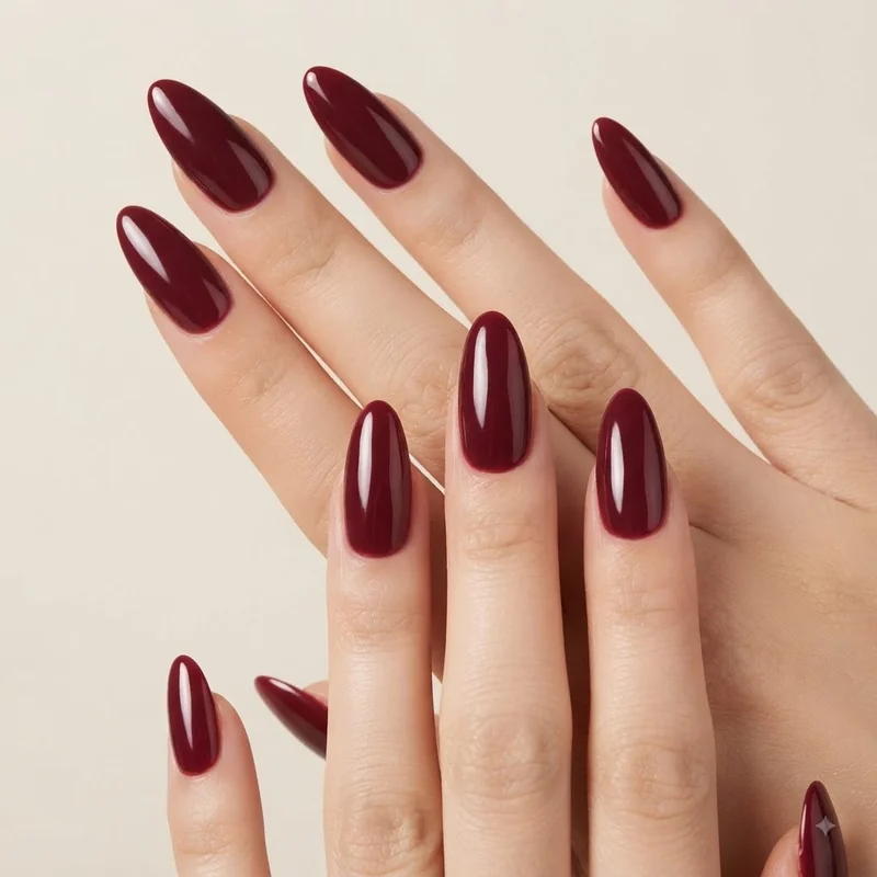 Close up of burgundy red christmas nails showing a durable, chip-resistant holiday manicure finish