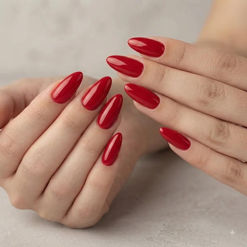 Glossy red almond nails, classic holiday manicure with a high-shine creme finish