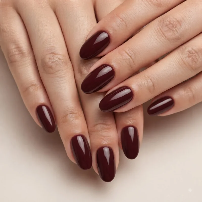 Deep burgundy oxblood short christmas nails glossy solid color finish for holiday manicure