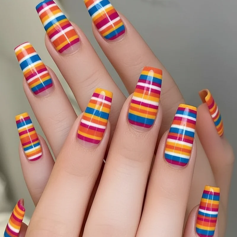 Serape stripe nails for Cinco de Mayo showing layered saffron yellow terracotta cobalt blue and deep magenta horizontal bands on short nails