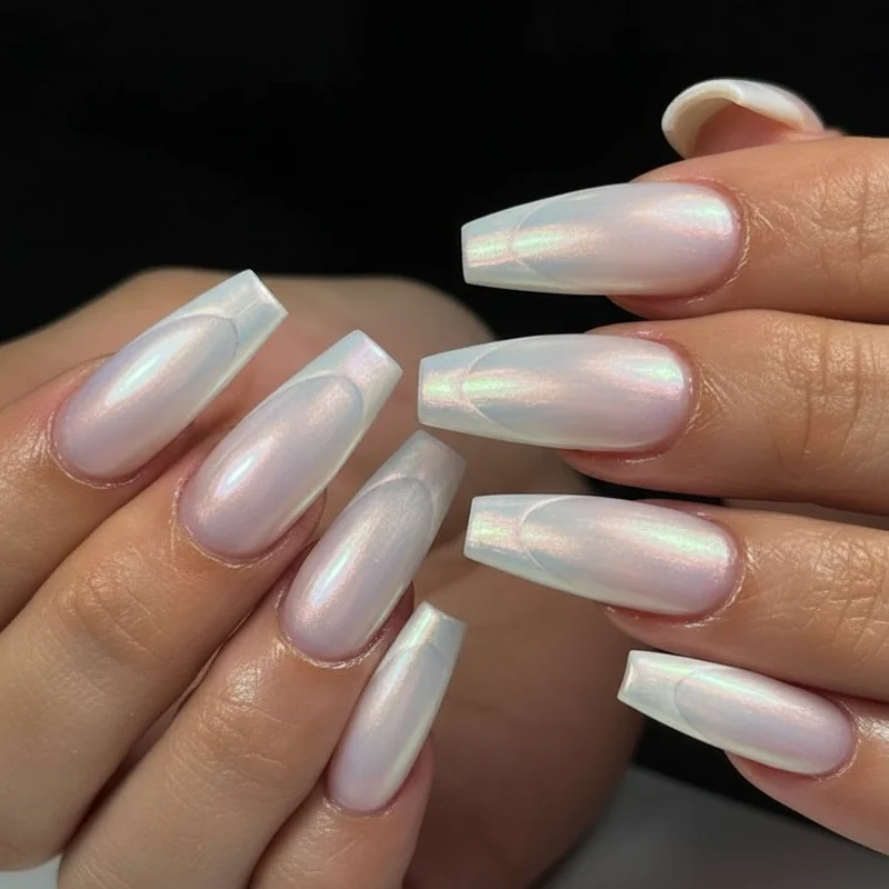 Bridal french tip coffin nails in pearl chrome over milky base showing soft opalescent wedding occasion finish that photographs in every light 2026