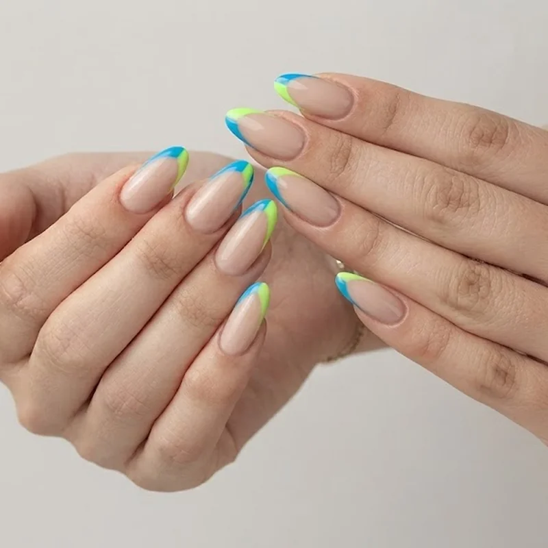 Neon french tips in electric blue and lime green over sheer nude base colorful y2k nails