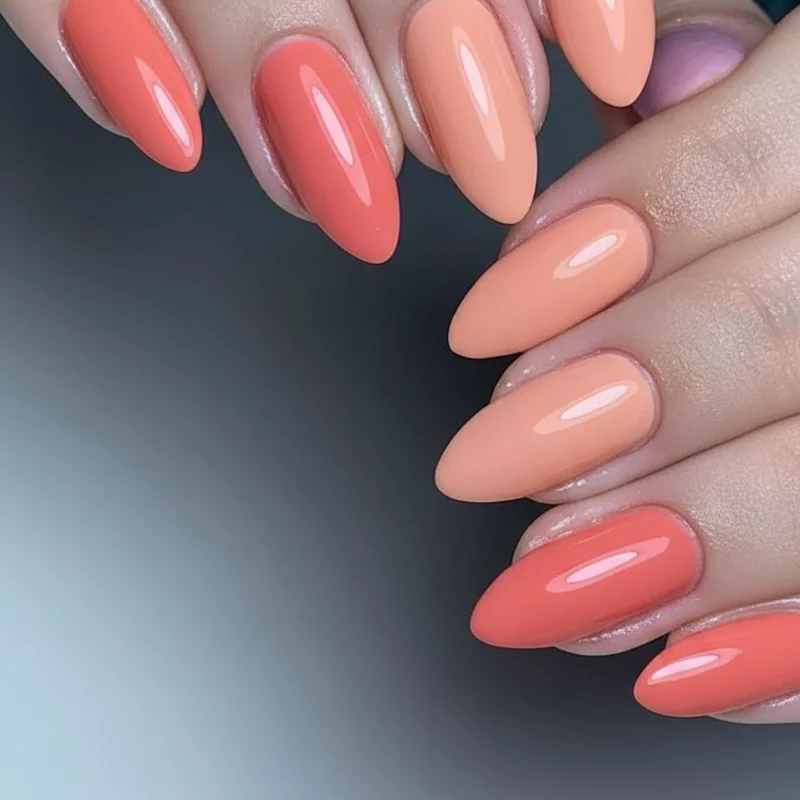 Best coral nail polishes 2026 featuring OPI Cajun Shrimp Essie Cute As A Button and Essie Peach Daiquiri with nail swatches