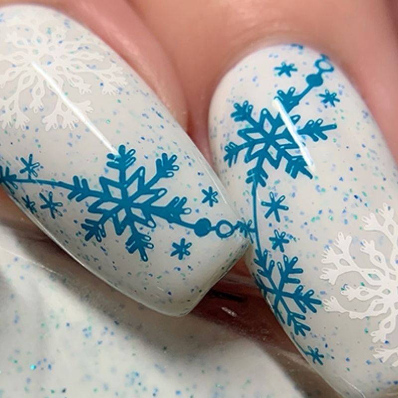 detailed intricate snowflake winter scene on white christmas nails with blue accents artistic hand painted design