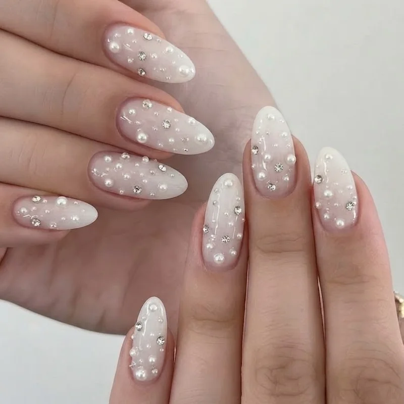 Diamond nails bridal look with pearl and crystal mix on a short almond shape wedding manicure idea