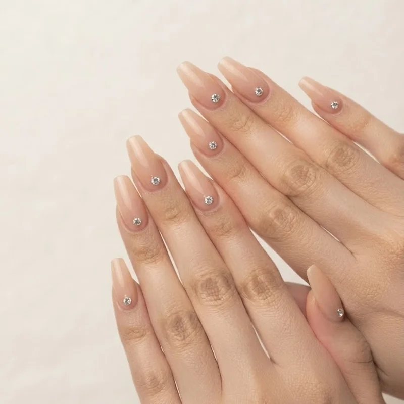 Diamond nails correct stone placement centered on the nail and away from the free edge in close up detail