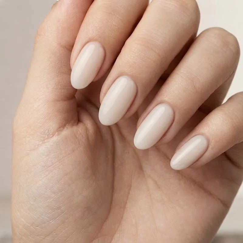 Glazed chrome dip powder nail idea with pearlescent mirror finish in soft champagne tone