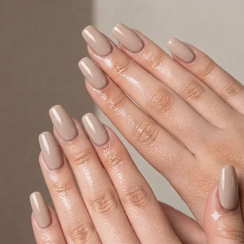 Squoval short dip nails in a soft neutral shade with a high gloss topcoat finish