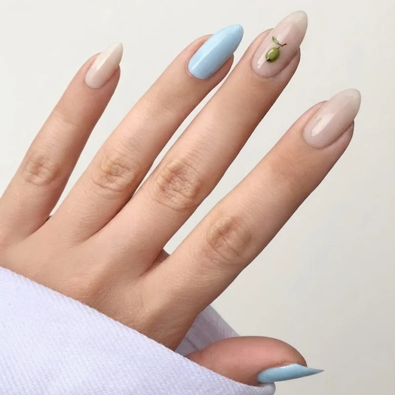 Baby blue and milky nude base dirty martini nails with tiny painted olive accent detail