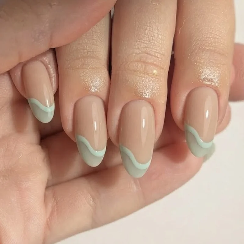 Sandy nude and seafoam nails with a subtle wave detail built for Castaway Cay beach days
