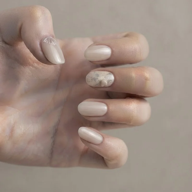 Hidden mickey nails with a subtle paint splatter accent and tucked silhouette detail, discreet manicure for everyday wear