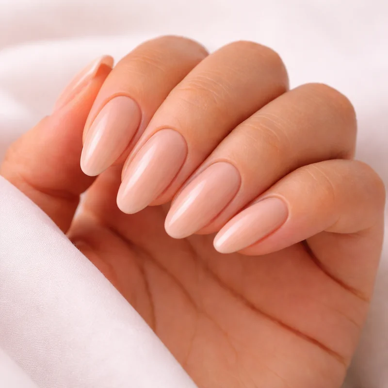 Wide nail bed with medium-length almond nails showing how the tapered tip counteracts nail plate width and creates a slimming visual effect at the fingertip