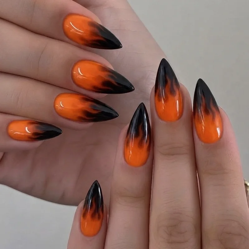 Fire dragon nail art with orange to black ombre on a stiletto shape design