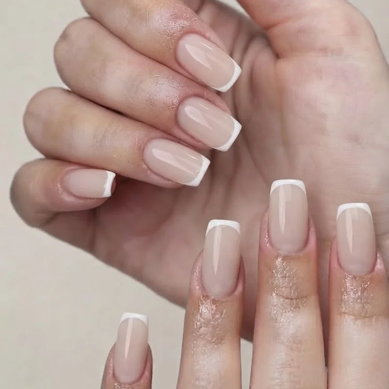 Milky neutral micro French tip end of august nails on short squoval nails for back to school routine
