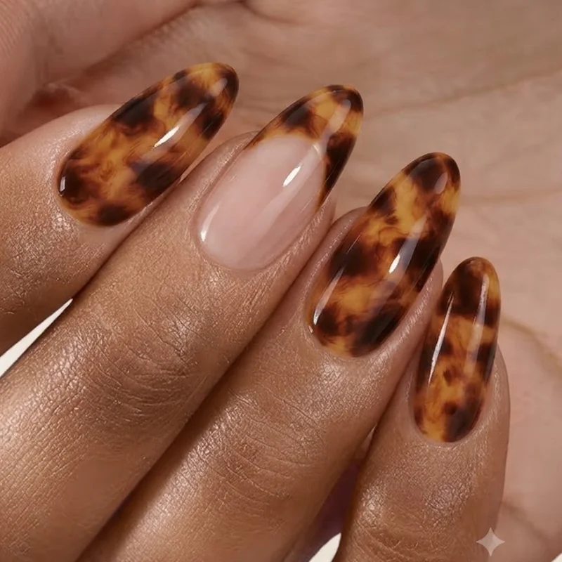 Brown tortoiseshell nail art design for fall with layered amber and espresso tones