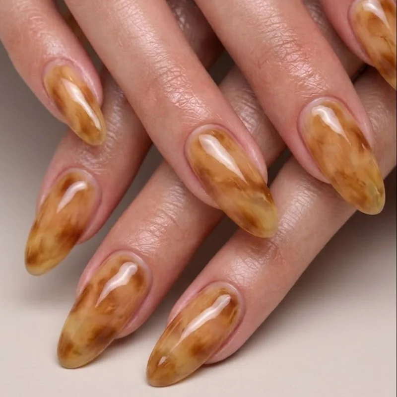 Blonde tortoiseshell nails fall honey and caramel soft layered manicure on natural nail length