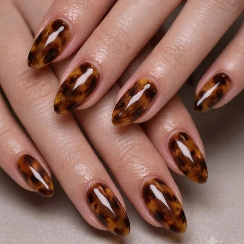Tortoise shell nails fall editorial styling with trend-forward layered brown and amber manicure