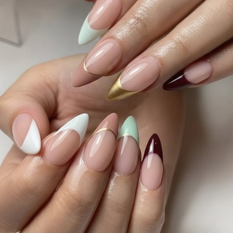 Reverse french manicure colour combinations showing white on nude gold on dark burgundy and pastel arc on sheer base options
