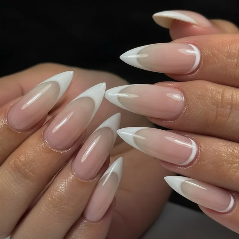 Reverse french manicure on short nails showing micro arc at cuticle line in nude base with white accent everyday wearable design