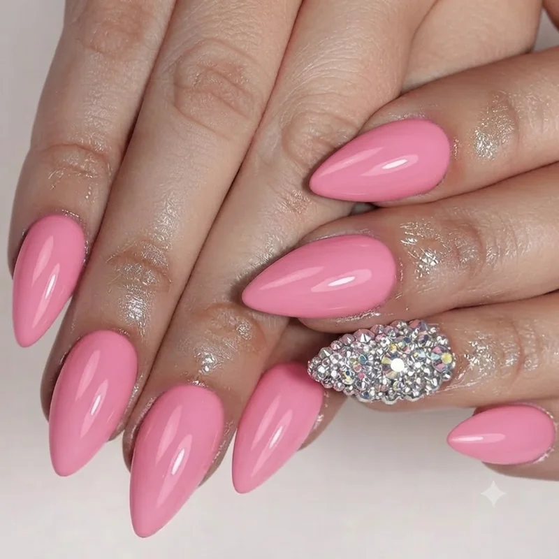 Barbie pink nails with a rhinestone accent nail, a sparkle detail on an otherwise solid barbiecore manicure